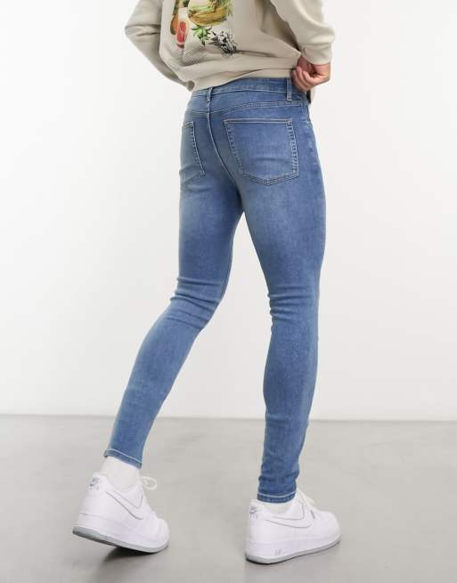 ASOS DESIGN mid rise comfort stretch straight leg jeans in midwash