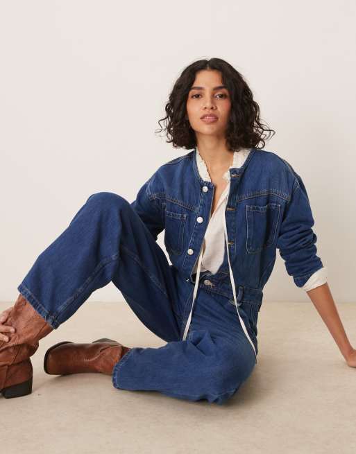 ASOS DESIGN premium collarless denim jumpsuit in midwash blue
