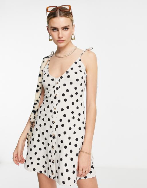 ASOS DESIGN - Prendisole corto color pietra a pois neri con bottoni e allacciatura sulle spalle