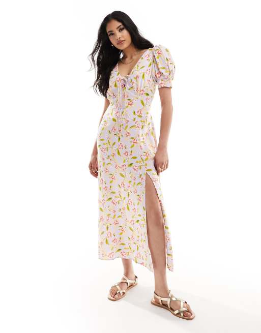 Model wearing a white and pink floral ASOS dress paired with silver white sandals