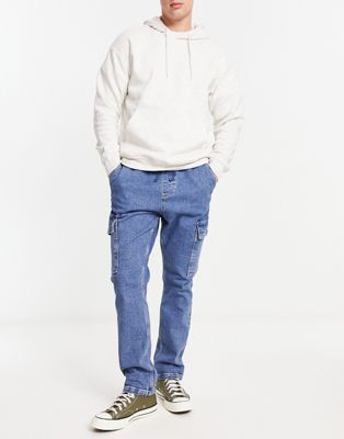 ASOS DESIGN pull on cargo jeans with cuffed hem in mid blue wash