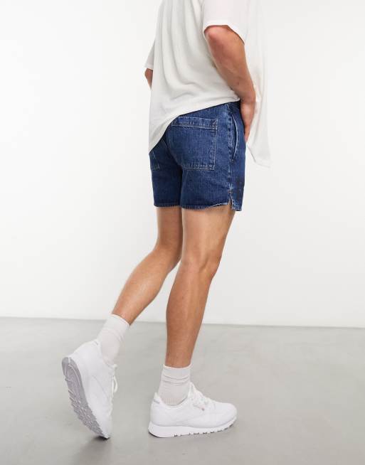 ASOS DESIGN stretch mid length denim shorts in flat mid wash blue