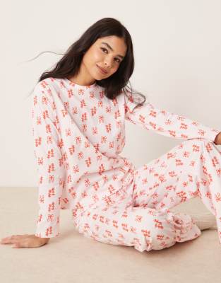 ASOS DESIGN - Pyjama mit langärmligem Oberteil und Hose in Rosa mit Schleifen-Print in Rot