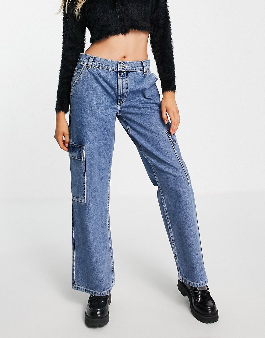 ASOS DESIGN recycled cotton blend low rise 'cargo' jean in mid wash blue