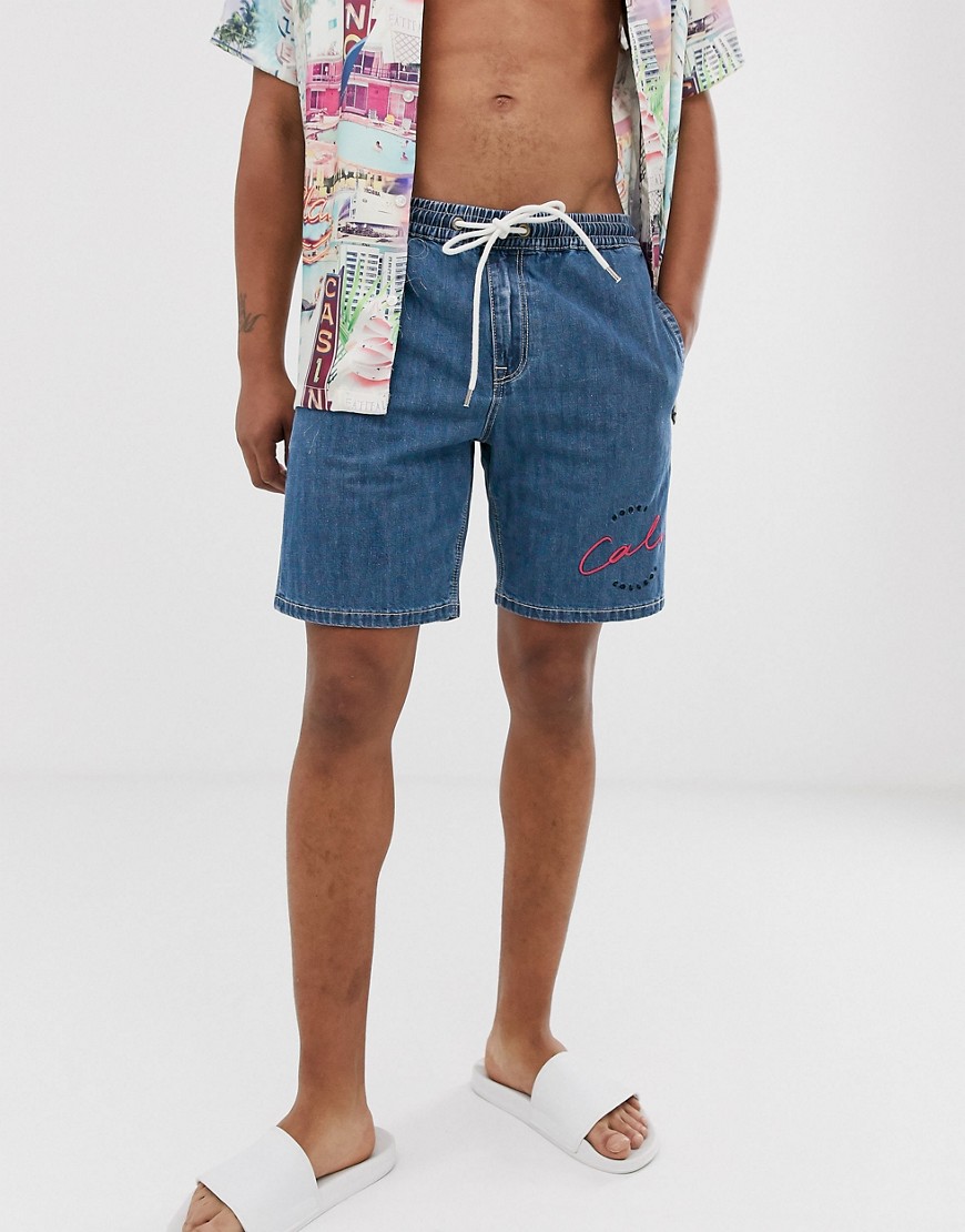 ASOS DESIGN relaxed fit denim short in mid wash blue with embroidery