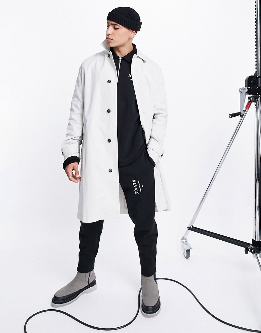 ASOS DESIGN relaxed fit ecru trench coat with check panel details-White