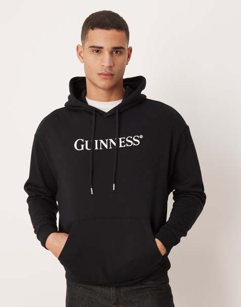 ASOS DESIGN – Relaxed-Fit-Kapuzenpullover in Schwarz mit „Guinness“-Print - view 1