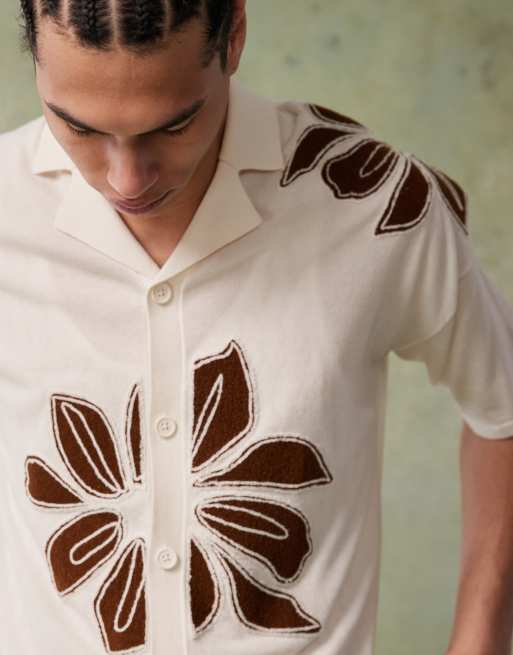 ASOS DESIGN relaxed boxy fit knitted button through polo with floral embroidery in ecru