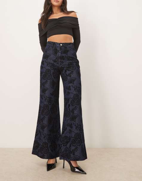 ASOS DESIGN relaxed flare jean with paisley flock in mid blue