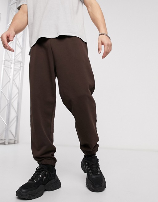 ASOS DESIGN oversized joggers in brown with back leg text print