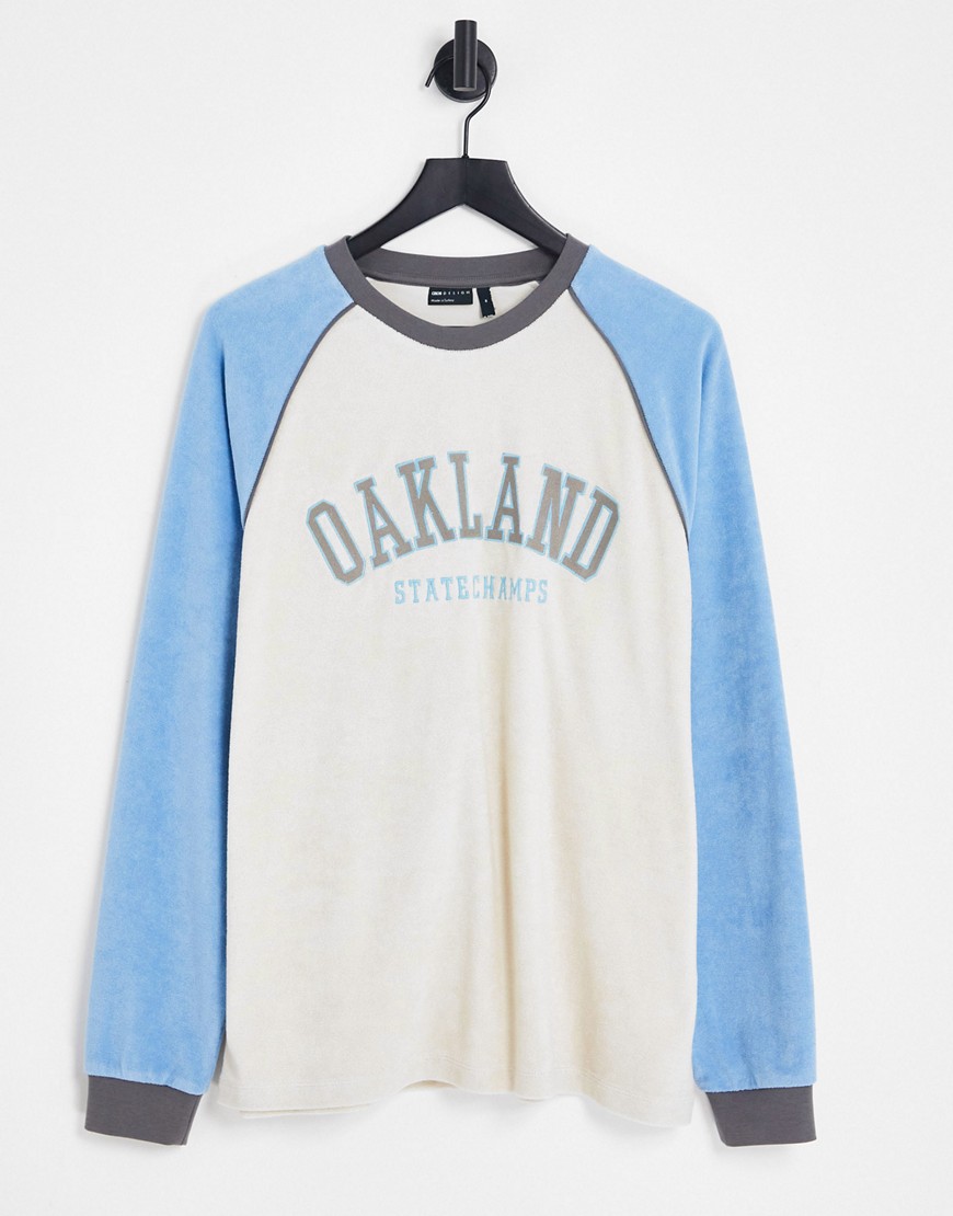 ASOS DESIGN relaxed long sleeve t-shirt in neutral and blue towelling with Oakland city print