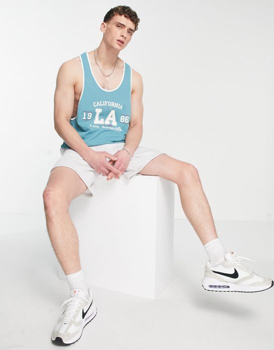 https://images.asos-media.com/products/asos-design-relaxed-racer-back-tank-top-with-la-collegiate-print/202571340-4?$n_550w$&wid=550&fit=constrain
