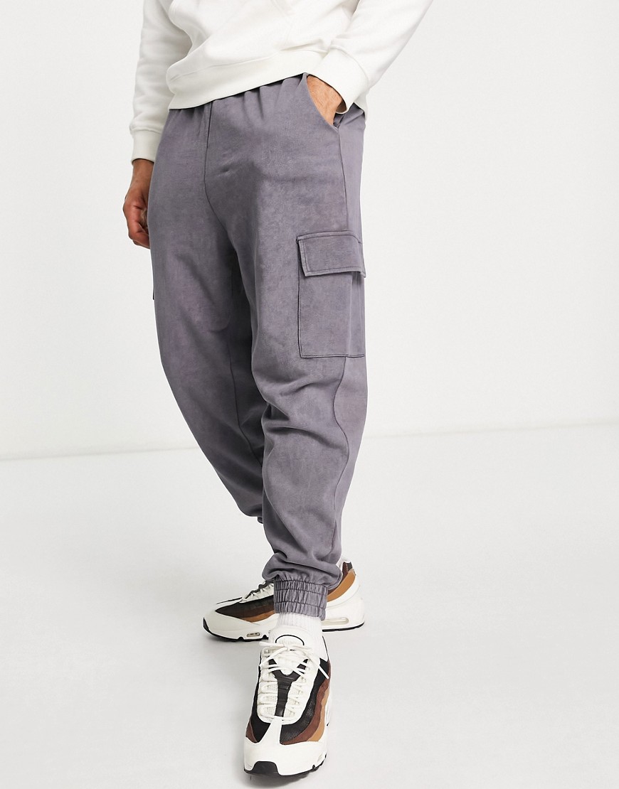 ASOS DESIGN relaxed sweatpants in black acid wash with cargo pocket