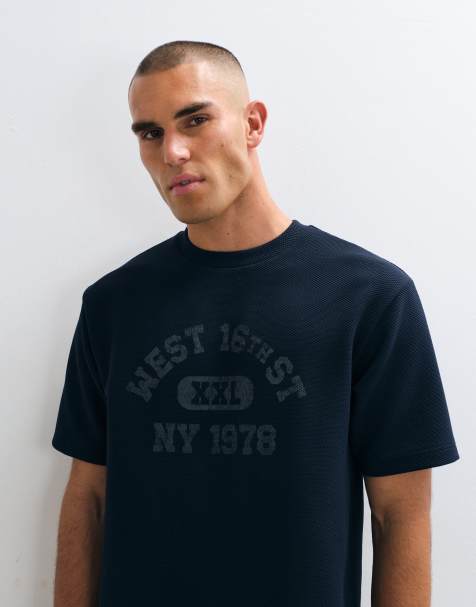 ASOS DESIGN relaxed t-shirt with collegiate graphic in navy - view 1
