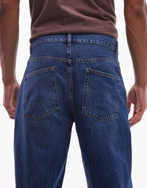 ASOS DESIGN relaxed tapered jeans in dark wash blue, 4 of 5