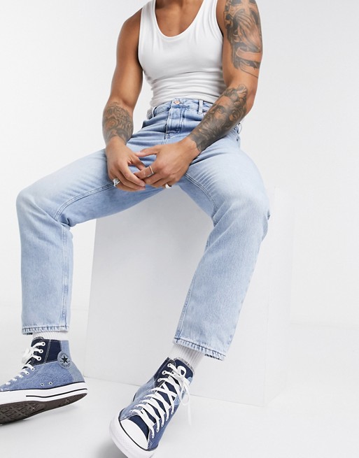 ASOS DESIGN relaxed tapered jeans in light blue stone wash