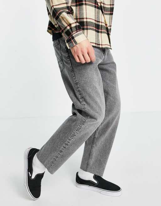 ASOS DESIGN relaxed tapered jeans in washed black with raw hem