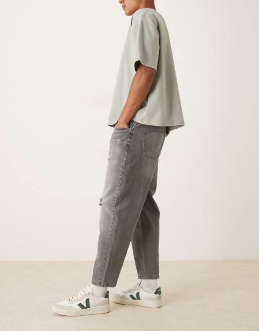ASOS DESIGN relaxed tapered jeans in washed black with rips
