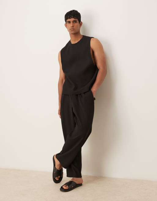ASOS DESIGN relaxed tapered plisse sweatpants in black