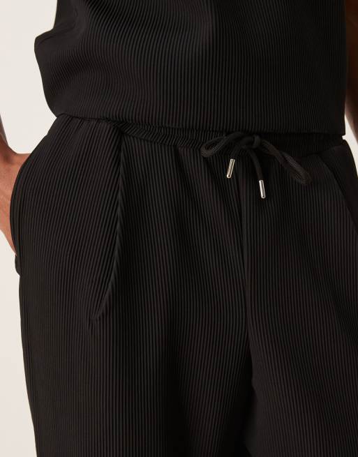 ASOS DESIGN relaxed tapered plisse sweatpants in black