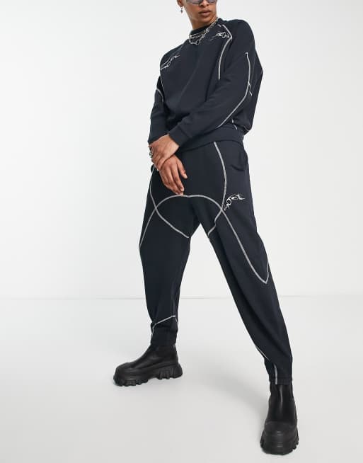 ASOS DESIGN relaxed trackies in black with tattoo print and stitching detail (part of a set)