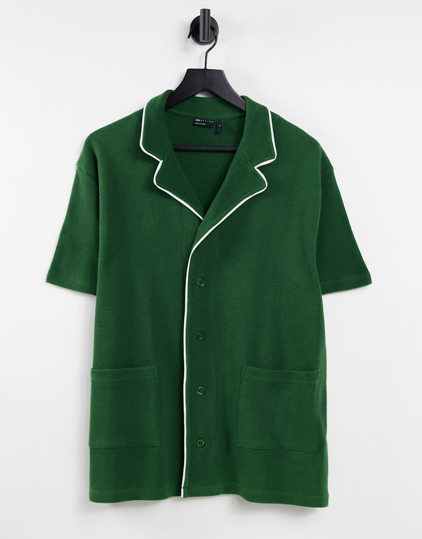 ASOS DESIGN relaxed waffle polo with pockets in green with white piping