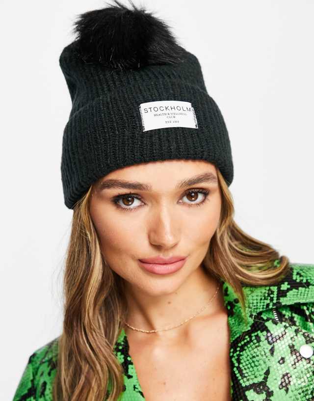 ASOS DESIGN rib knit pom beanie with label detail in black