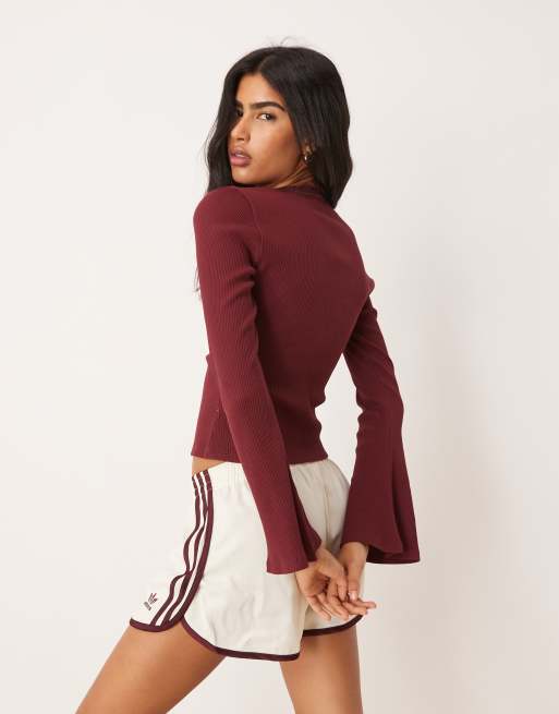 ASOS DESIGN ribbed v neck top with lace trim and flared sleeve in burgundy