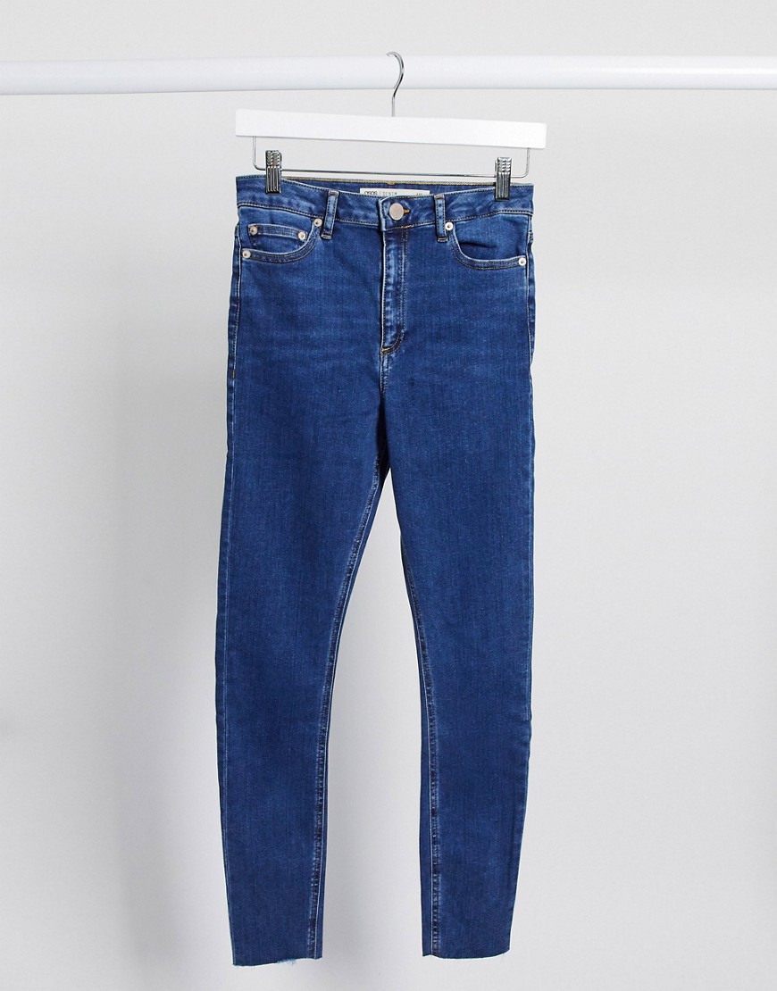 ASOS DESIGN Ridley high rise skinny jeans in bright mid-wash blue with raw hem-Blues