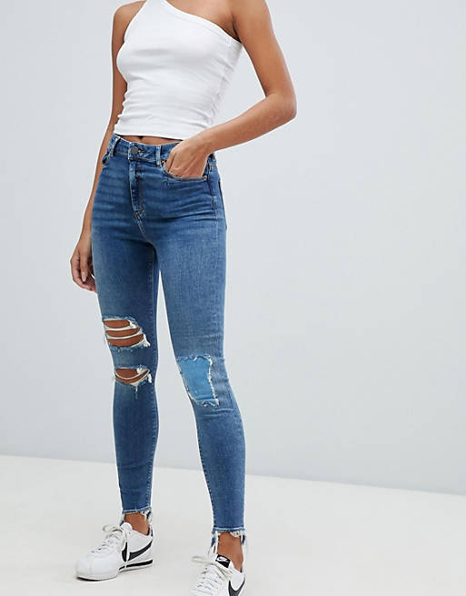 ASOS DESIGN Ridley high waist skinny jeans in extreme mid wash with busted knee and rip & repair detail