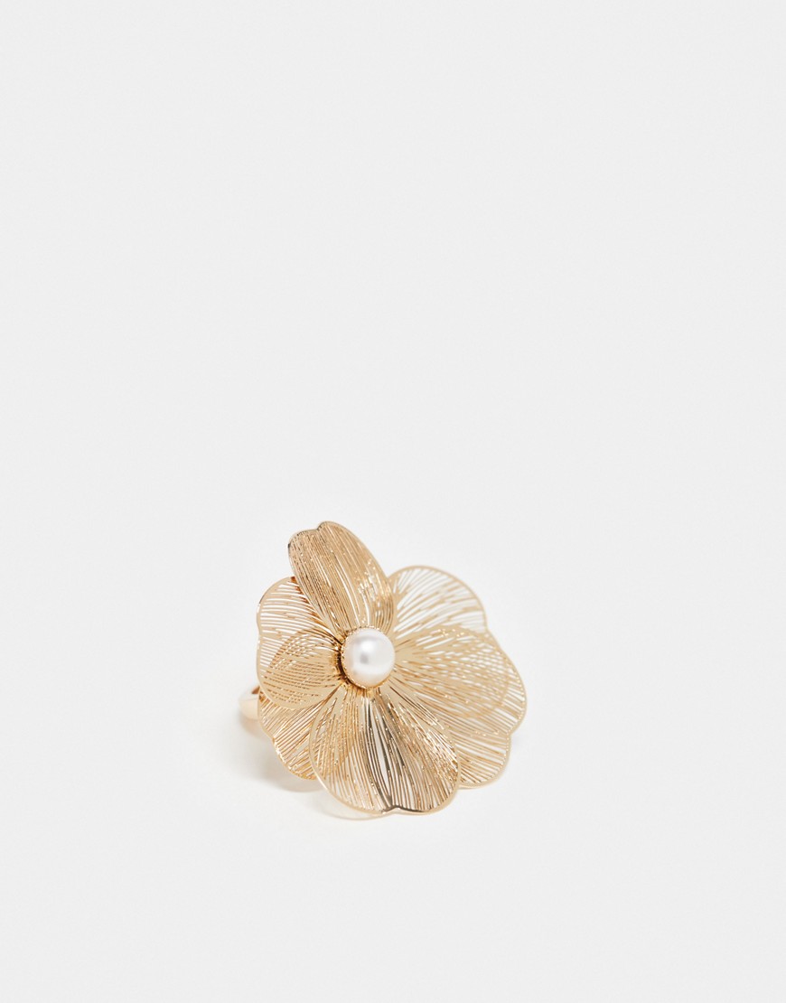 ring with sculptural flower design in gold tone