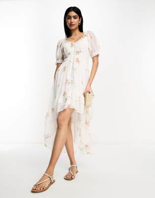 ASOS DESIGN – Rosa blommig klänning med knäppning, ojämn fåll och broderade volanger