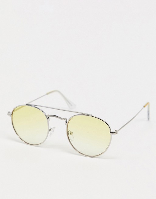 ASOS DESIGN round sunglasses in silver metal with brow bar and yellow lens