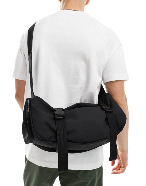 ASOS DESIGN rubberised cross body bag with pocket and buckle detail in black, 3 of 4