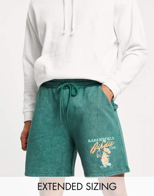 ASOS DESIGN - Ruimvallende shorts met sportprint met cartoon in groene acid wash
