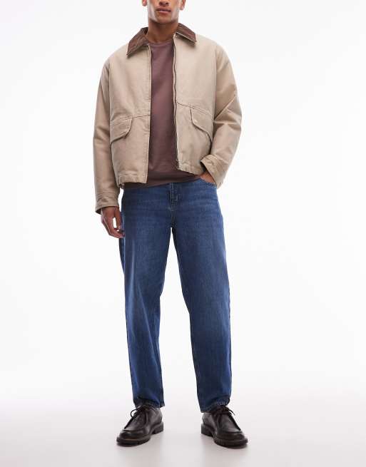 ASOS DESIGN - Ruimvallende smaltoelopende jeans in donkere wassing in blauw