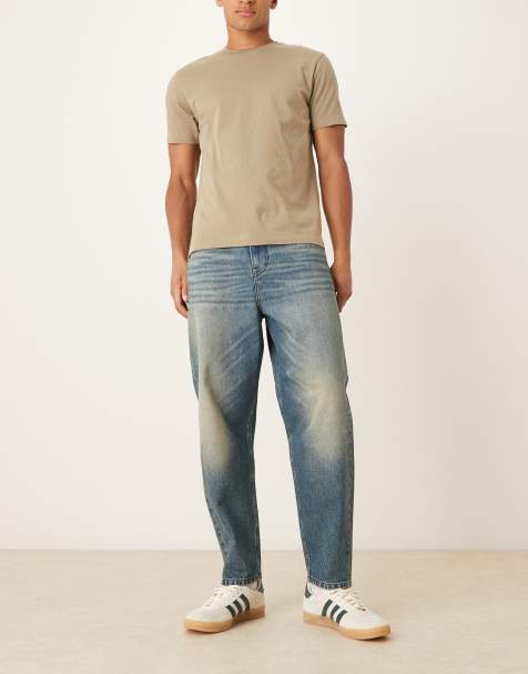 ASOS DESIGN - Ruimvallende taps toelopende jeans in donkerblauwe wassing met tint - view 1