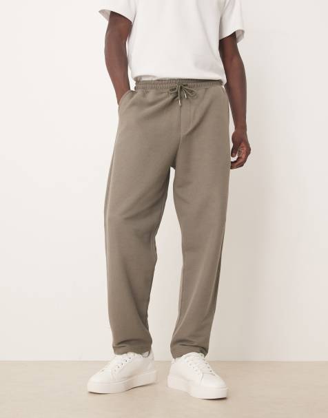 ASOS DESIGN - Ruimvallende toelopende joggingbroek van piqué katoen in kaki - view 1