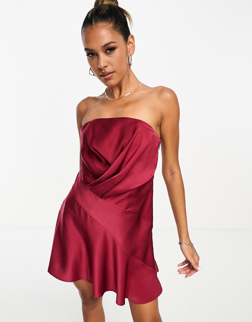 ASOS DESIGN satin bandeau asymetric hem mini dress with ruched bodice detail in burgundy-Red