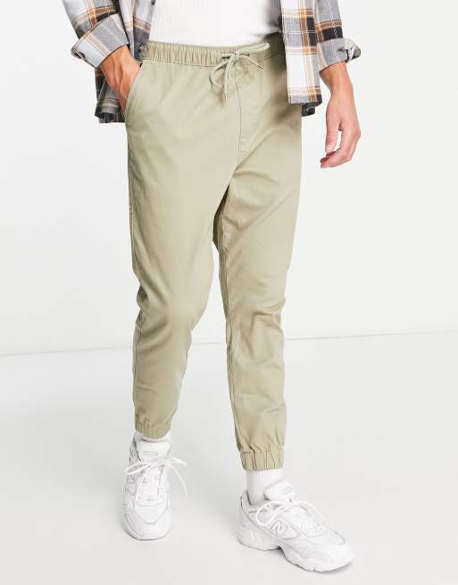 ASOS DESIGN – Schmal geschnittene Jogginghose aus Webstoff in Dunkelbeige