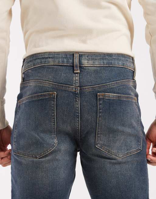 ASOS DESIGN – Schmal geschnittene Stretch-Jeans in verwaschenem Mittelblau mit Vintage-Waschung, 4 von 5