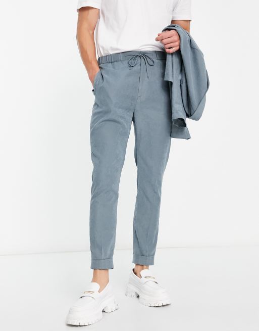 ASOS DESIGN – Schmal zulaufende Anzughose mit Jogginghosenbund im Wildleder-Look, in gedecktem Blau
