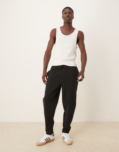 ASOS DESIGN – Schmal zulaufende Doubleface-Jogginghose in Schwarz mit Biesen - view 1