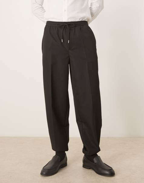 ASOS DESIGN – Schmal zulaufende Hose in Schwarz mit elastischem Bund und Bündchen - view 1