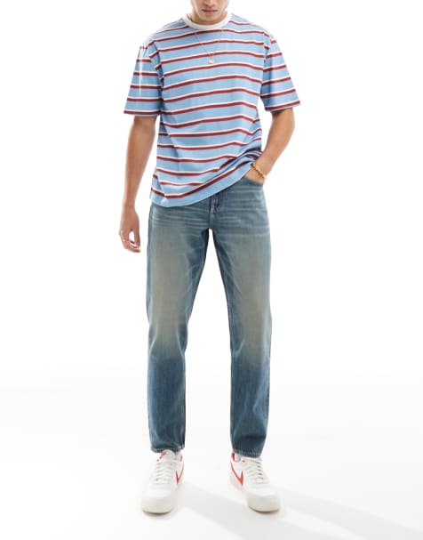 ASOS DESIGN – Schmal zulaufende Jeans in verwaschenem Mittelblau mit Vintage-Farbstich - view 1