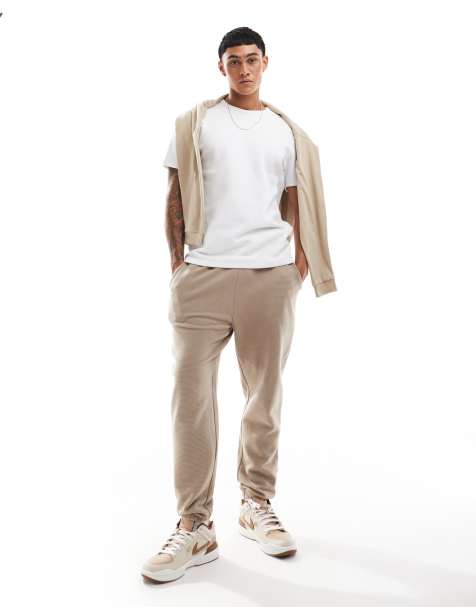 ASOS DESIGN – Schmal zulaufende Jogginghose in geripptem Beige - view 1