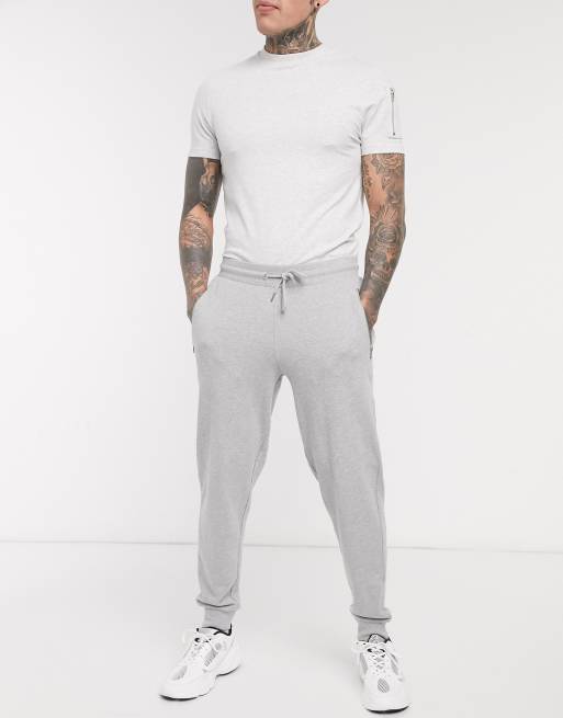 ASOS DESIGN – Schmal zulaufende Jogginghose in Grau meliert mit Taschen mit silberfarbenem Reißverschluss – GREY