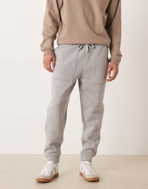 ASOS DESIGN – Schmal zulaufende Jogginghose in Grau meliert mit Taschen - view 1