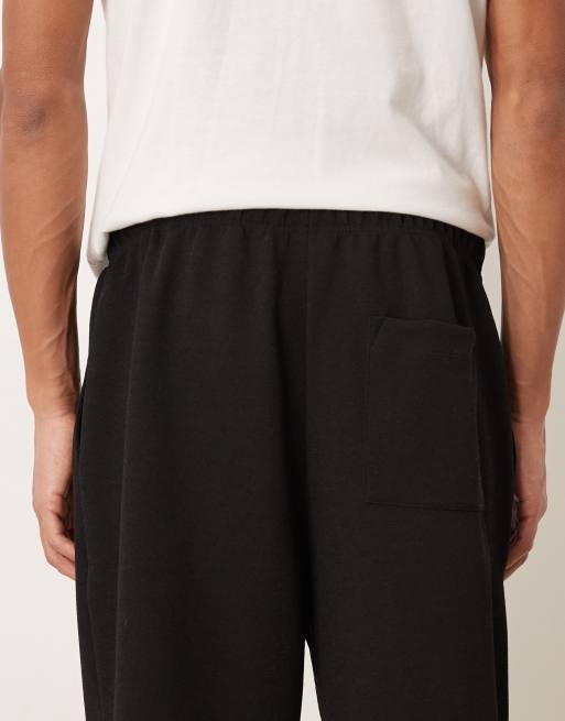 ASOS DESIGN – Schmal zulaufende Jogginghose in Schwarz mit Bundfalten, 5 von 5