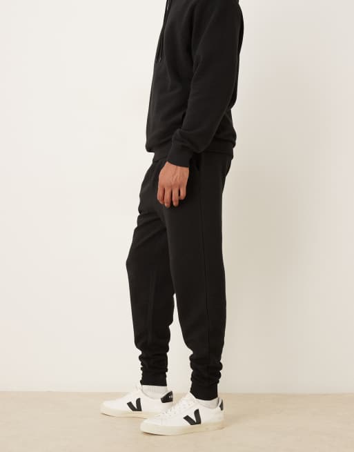 ASOS DESIGN – Schmal zulaufende Jogginghose in Schwarz mit gerippten Bündchen, Kombiteil, 3 von 5